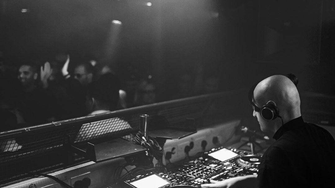 Sound engineer operating a live audio mixing console